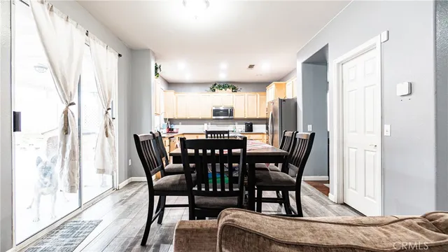 a view of a a dining room with furniture window and wooden floor