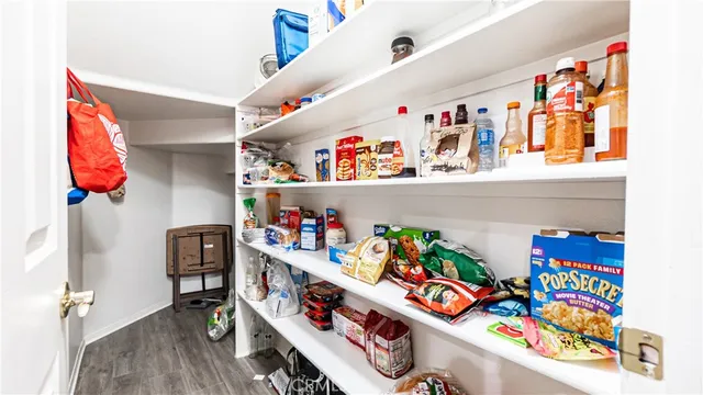 a view of entryway and gallery with wooden floor