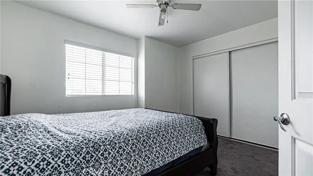 a bedroom with a bed and cabinet