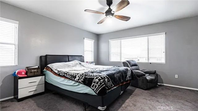 a bedroom with a bed couch and window