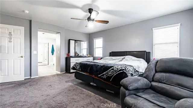 a bedroom with bed and a flat screen tv