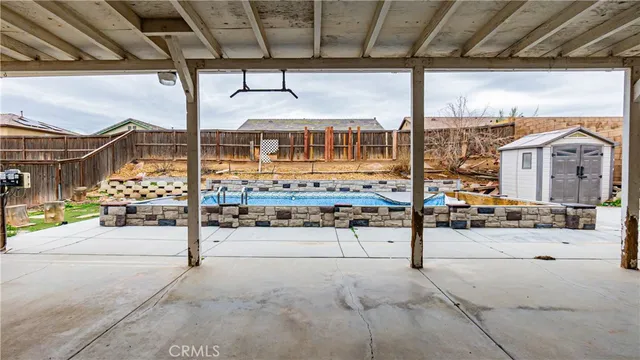 a view of a porch with a table and chairs