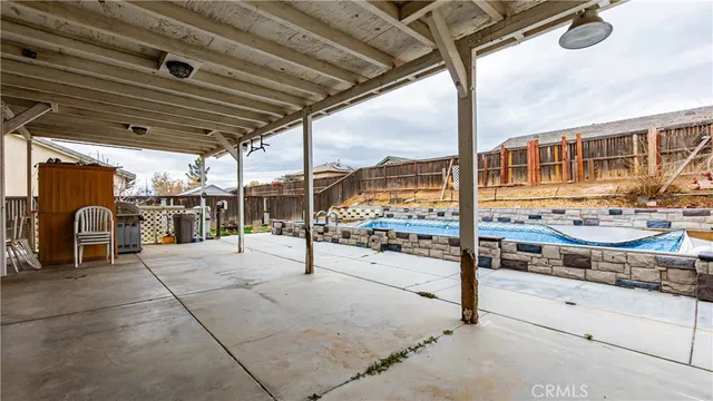 a view of a house with swimming pool and sitting area