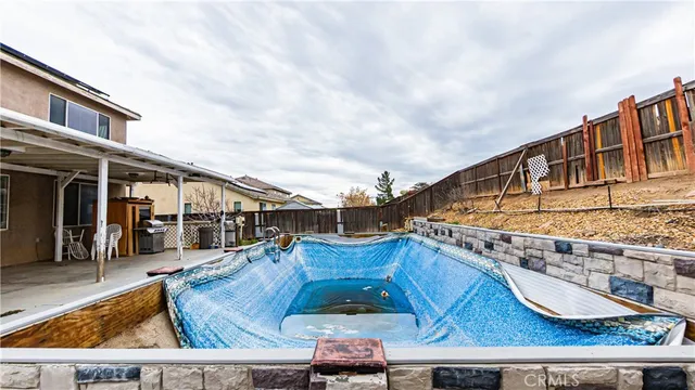 a view of a patio with swimming pool