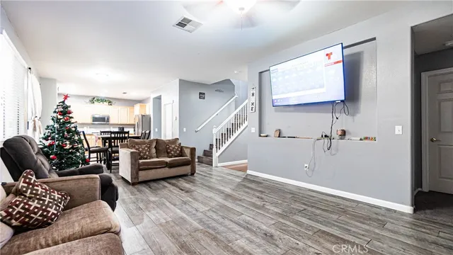 a living room with furniture and a wooden floor