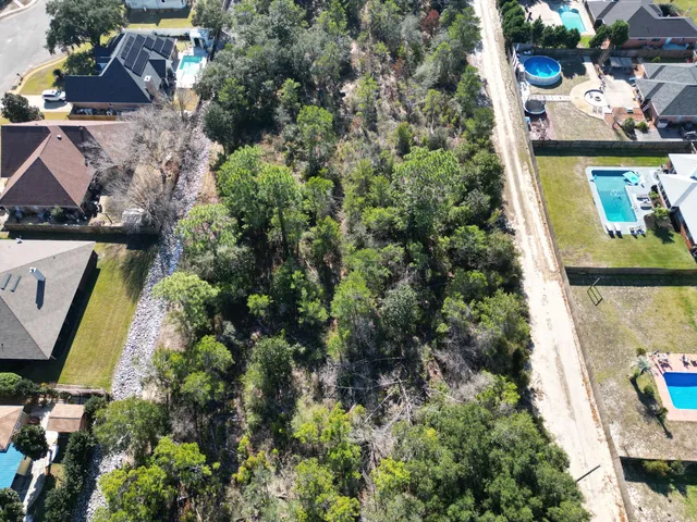 an aerial view of residential house with outdoor space and swimming pool