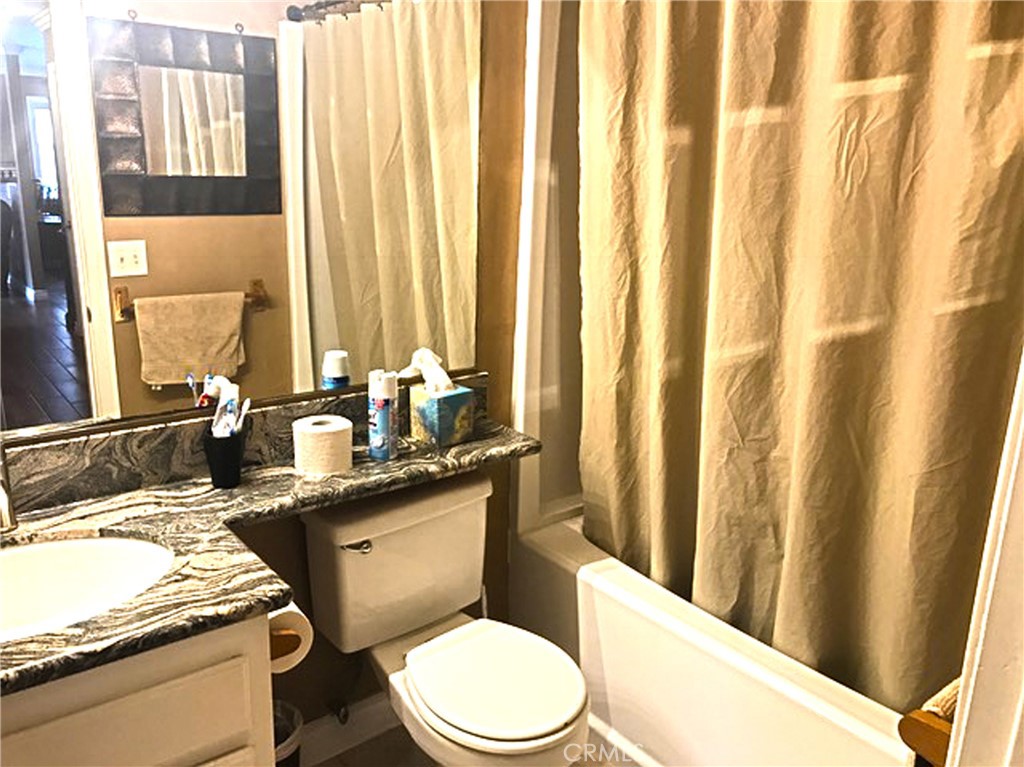 20011 Shorewood Circle Huntington Beach, CA 92646 - Photo 13 of 15 a bathroom with a granite countertop sink toilet and mirror