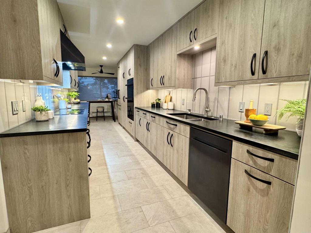375 West I Street Encinitas, CA 92024 - Photo 2 of 65 a kitchen with stainless steel appliances a sink dishwasher and cabinets with wooden floor