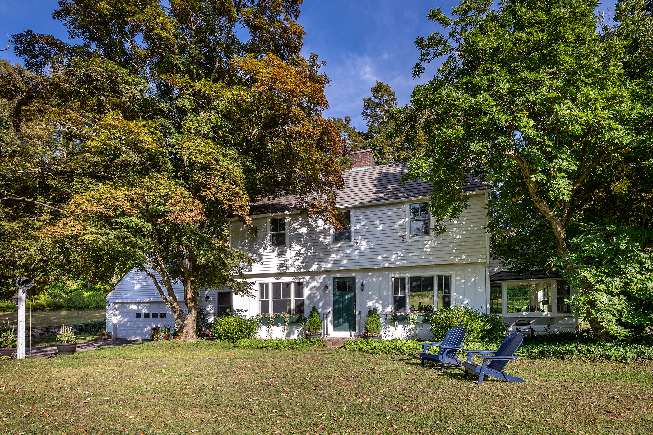 a front view of a house with garden