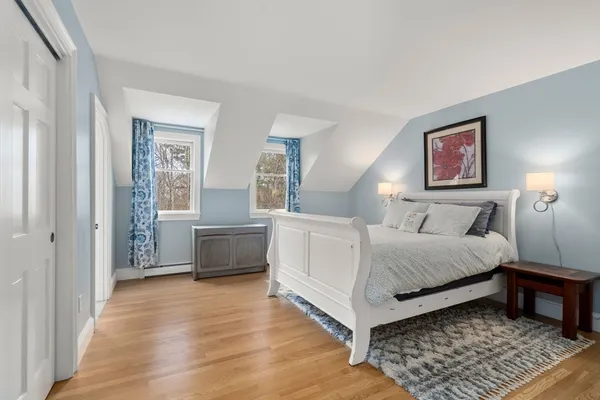 a bedroom with furniture and a rug