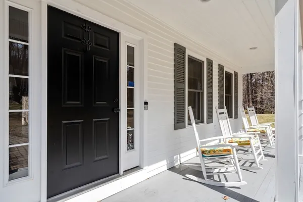 a view of front door of house with outdoor seating
