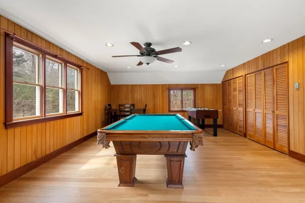 a room with pool table and windows