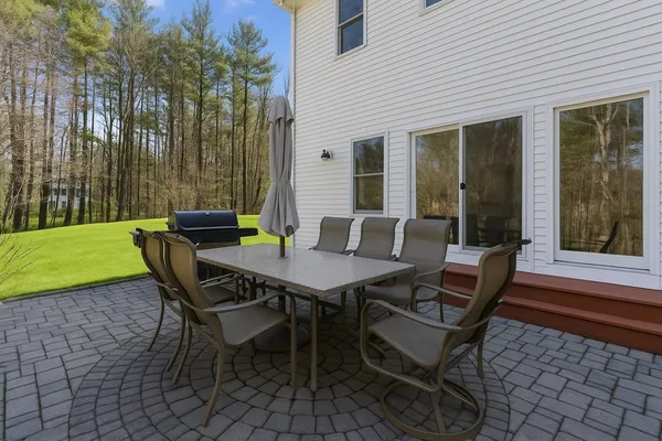 a view of a backyard with table and chairs