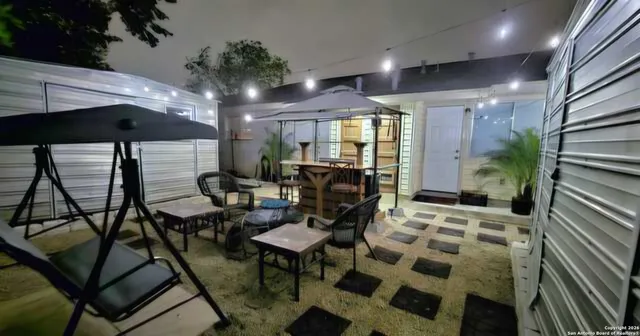 a view of a livingroom with furniture and a potted plant