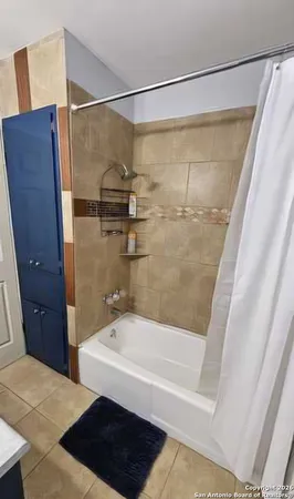 a bathroom with a bathtub and a shower