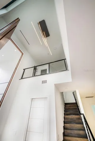 a view of a big room with wooden floor and windows