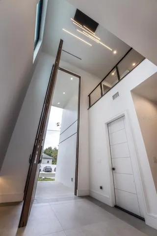 a view of kitchen with microwave and refrigerator