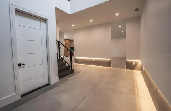 a kitchen with kitchen island a sink a stove and a large window