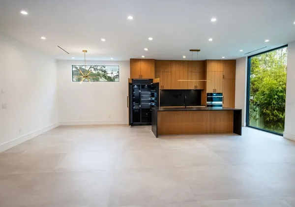 a view of a livingroom with wooden floor and a ceiling fan