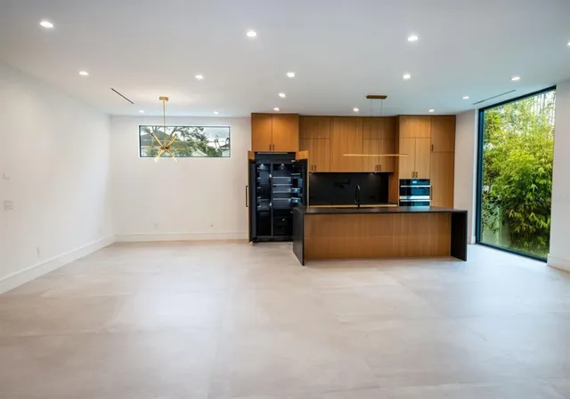 a view of a livingroom with wooden floor and a ceiling fan