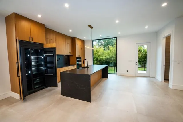a view of a hallway with wooden floor and stairs