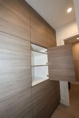 a view of a room with wooden floor and white walls