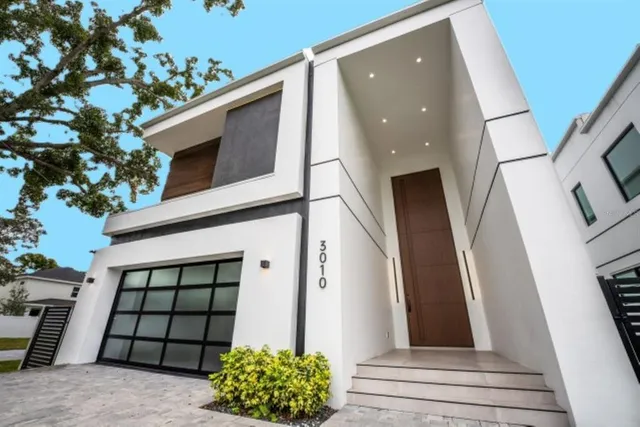 a view of staircase with railing and white walls