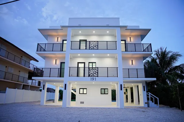 a front view of a multi story building with yard