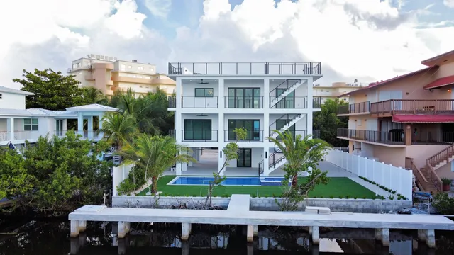 a front view of a house with a yard and potted plants