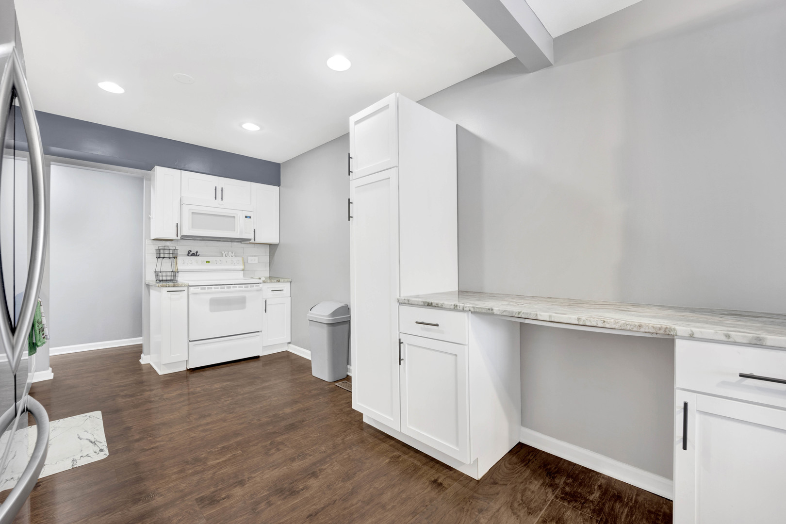 1495 South County Farm Road, Unit 12 Wheaton, IL 60189 - Photo 11 of 22 a kitchen with white cabinets and white appliances