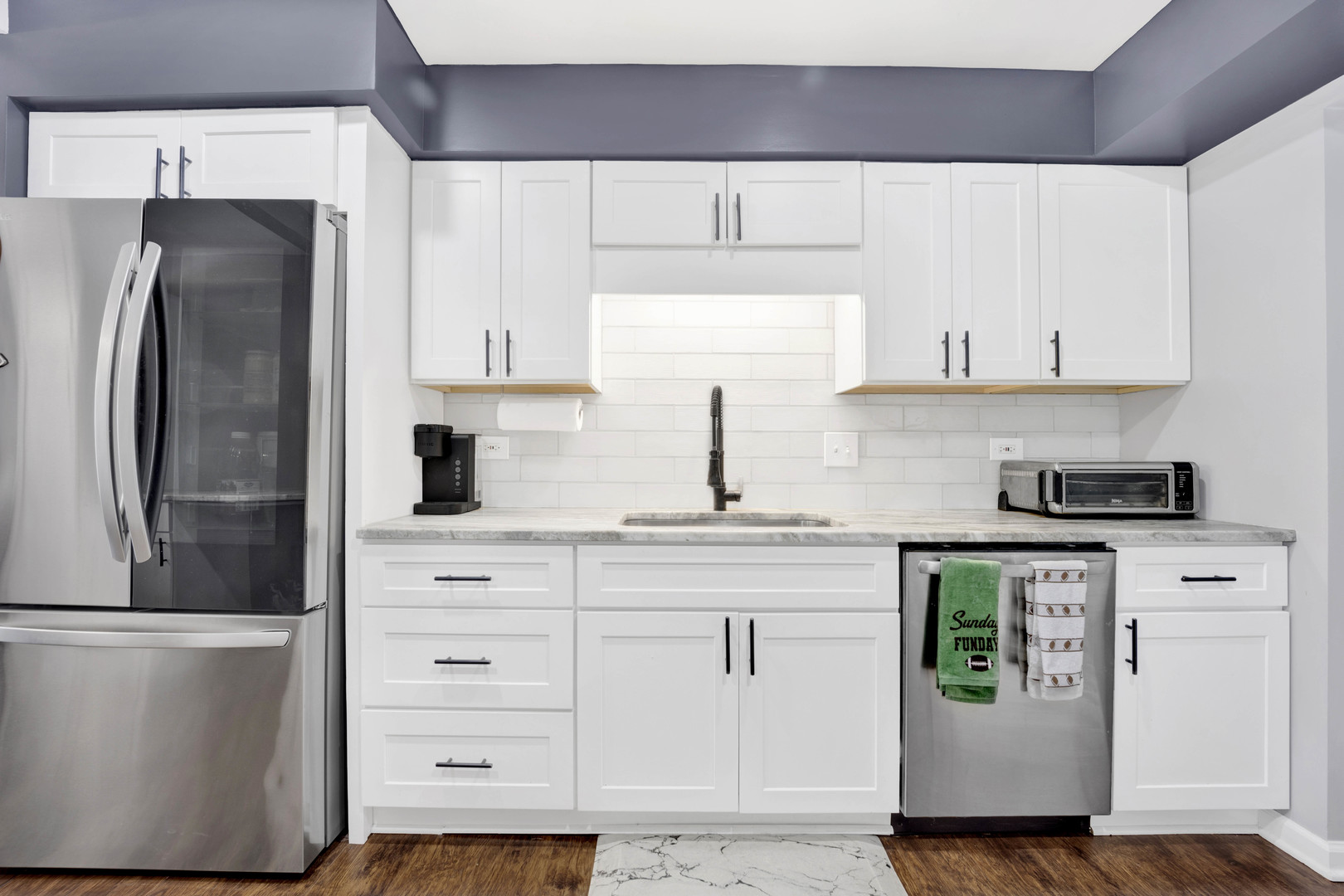 1495 South County Farm Road, Unit 12 Wheaton, IL 60189 - Photo 13 of 22 a kitchen with stainless steel appliances white cabinets and a refrigerator