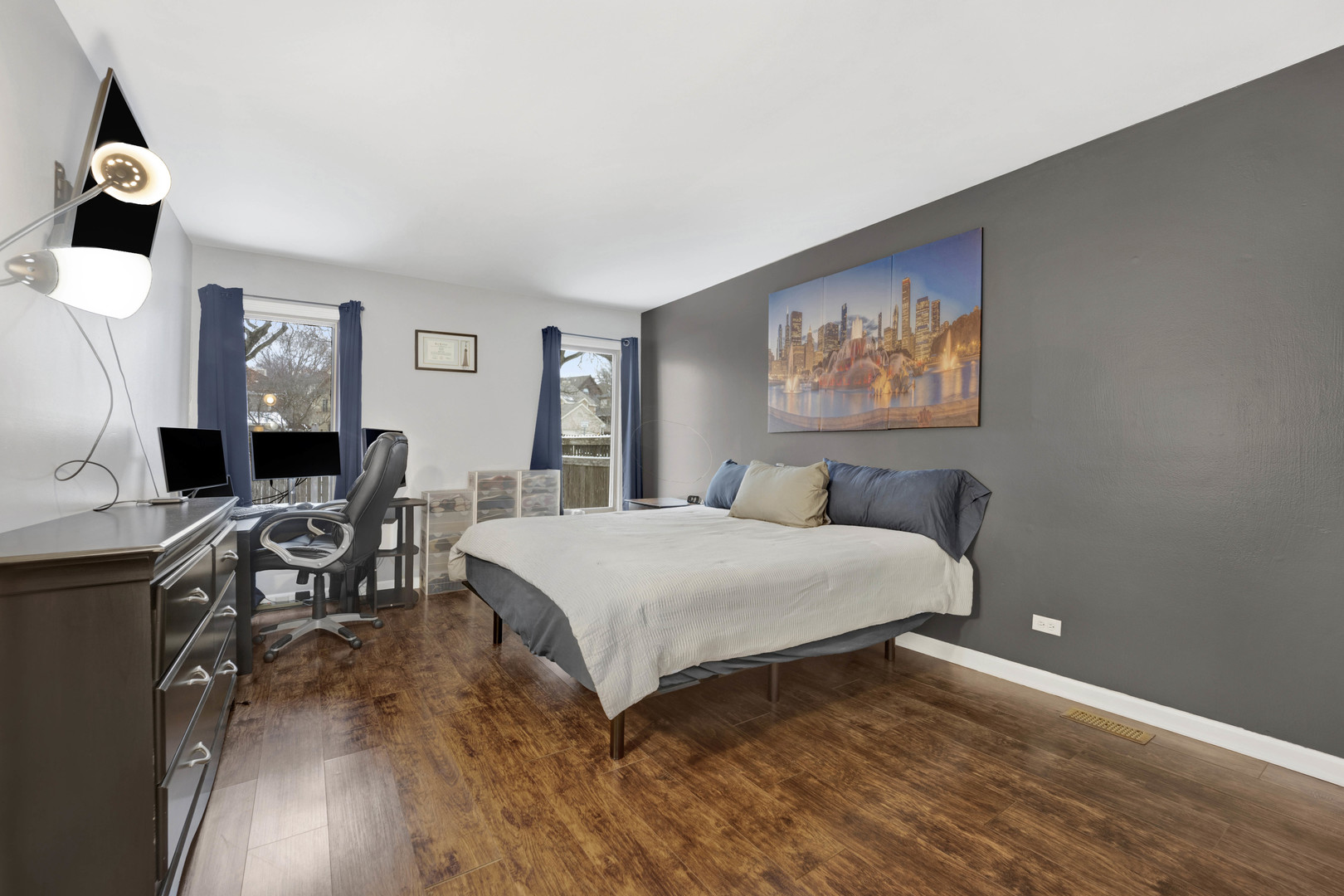 1495 South County Farm Road, Unit 12 Wheaton, IL 60189 - Photo 14 of 22 a bedroom with a bed and wooden floor