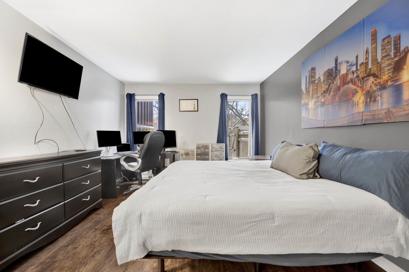 1495 South County Farm Road, Unit 12 Wheaton, IL 60189 - Photo 15 of 22 a bedroom with a bed and flat screen tv