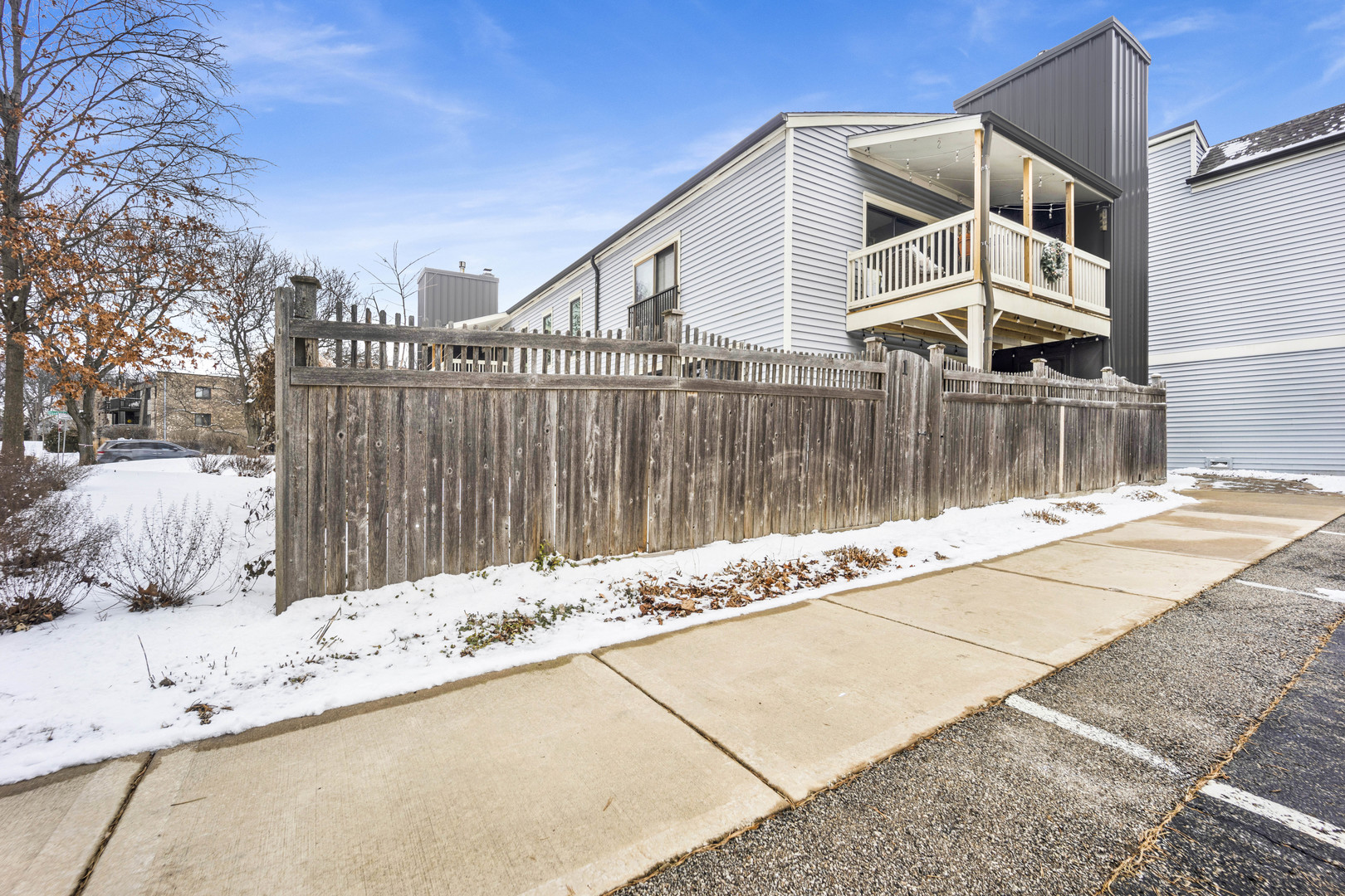 1495 South County Farm Road, Unit 12 Wheaton, IL 60189 - Photo 2 of 22 a view of a house with a wooden fence