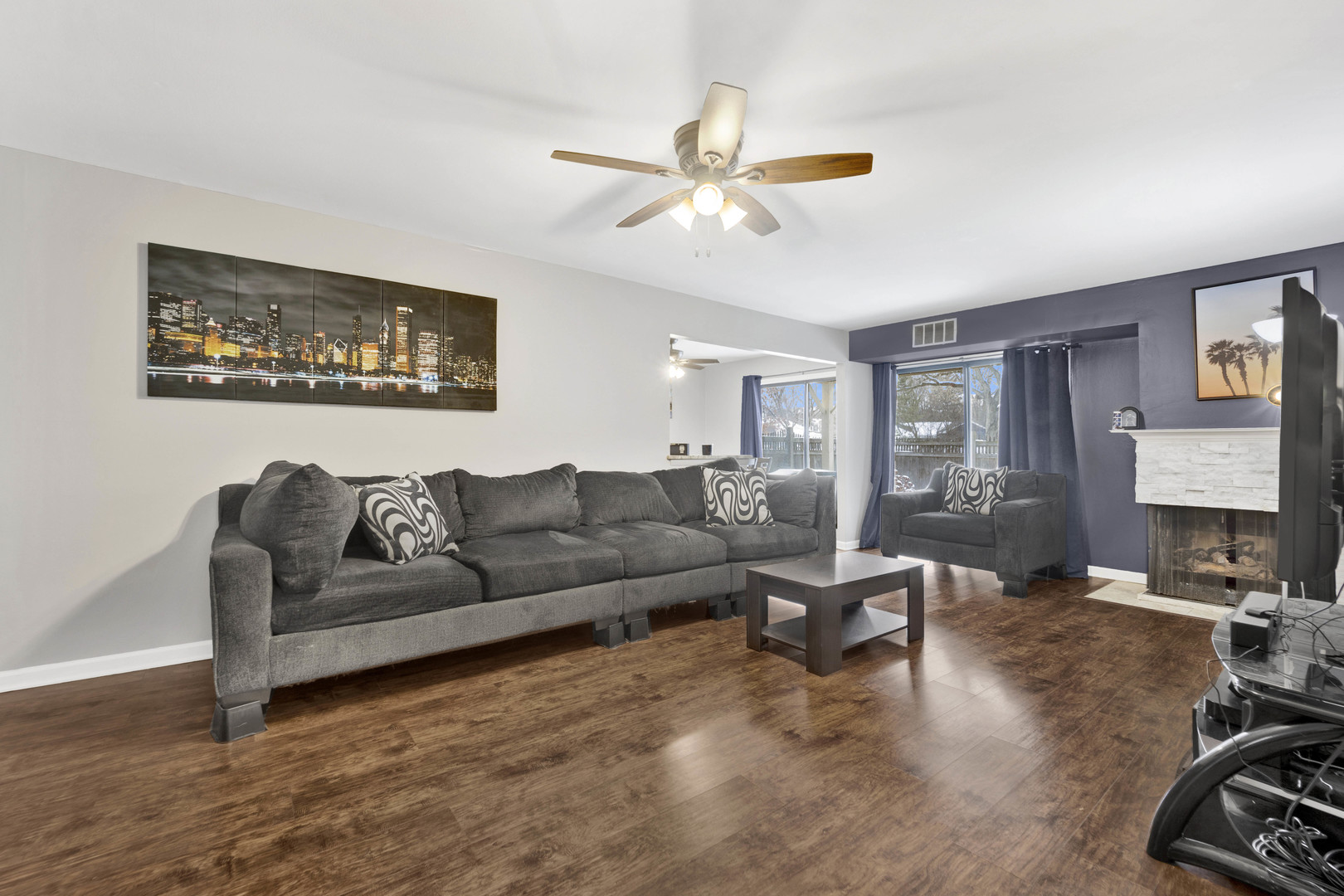 1495 South County Farm Road, Unit 12 Wheaton, IL 60189 - Photo 3 of 22 a living room with furniture and a flat screen tv