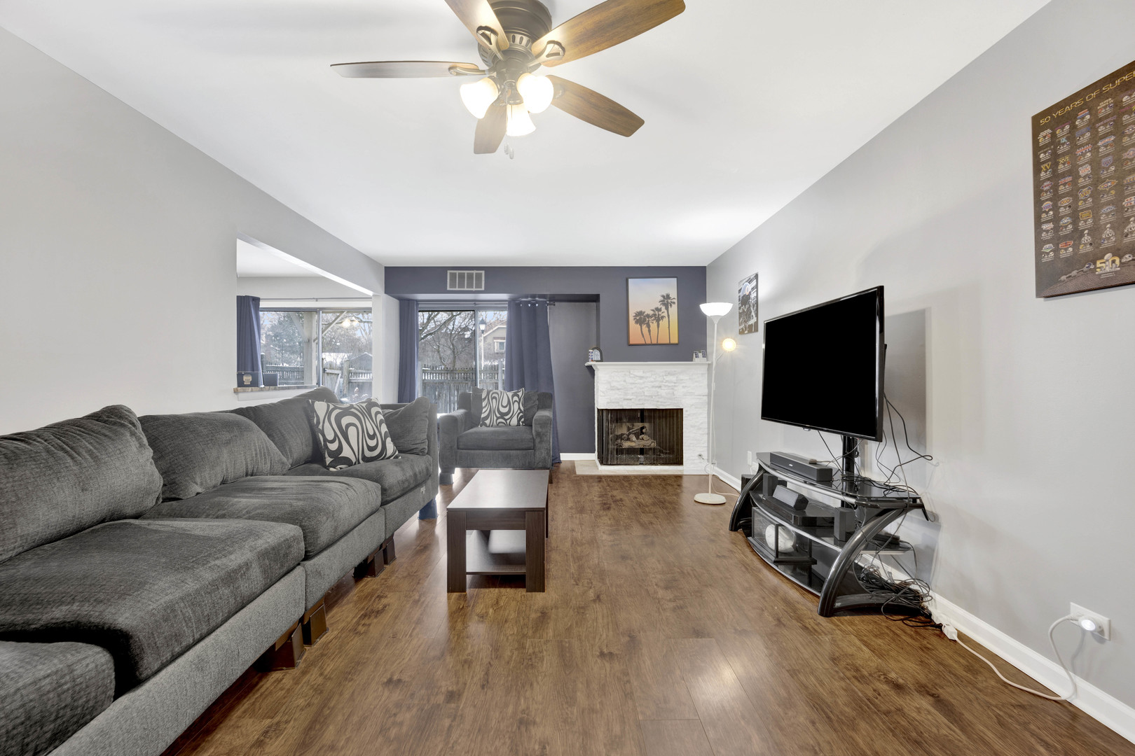 1495 South County Farm Road, Unit 12 Wheaton, IL 60189 - Photo 4 of 22 a living room with furniture and a flat screen tv