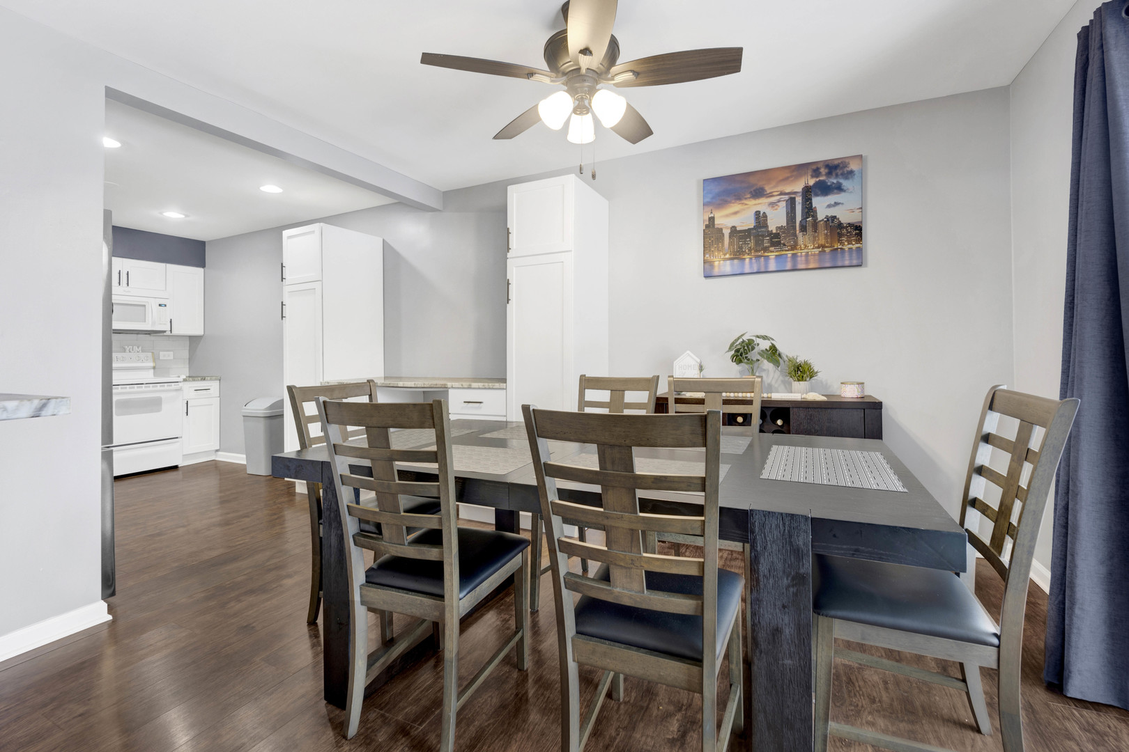 1495 South County Farm Road, Unit 12 Wheaton, IL 60189 - Photo 8 of 22 a view of a dining room with furniture and wooden floor