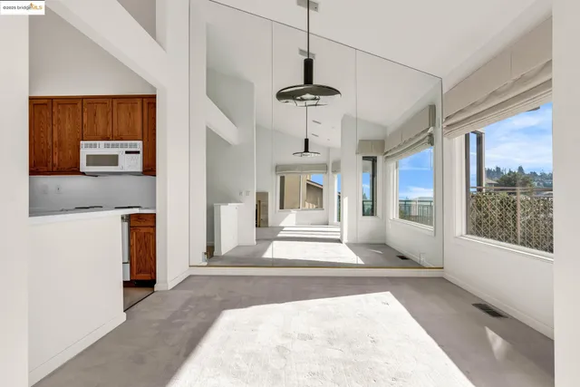a view of a hallway with a chandelier and living room view
