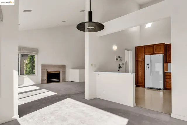 a view of a livingroom with a fireplace and cabinet