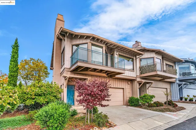 a front view of a house with plants