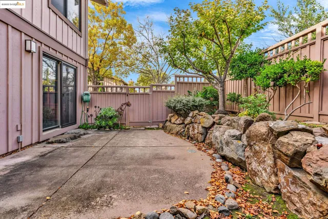 a view of backyard with a table and chairs and potted plants