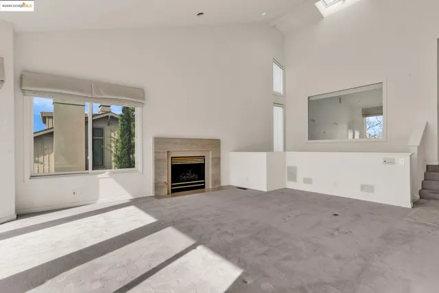 a view of a livingroom with an empty space and a fireplace