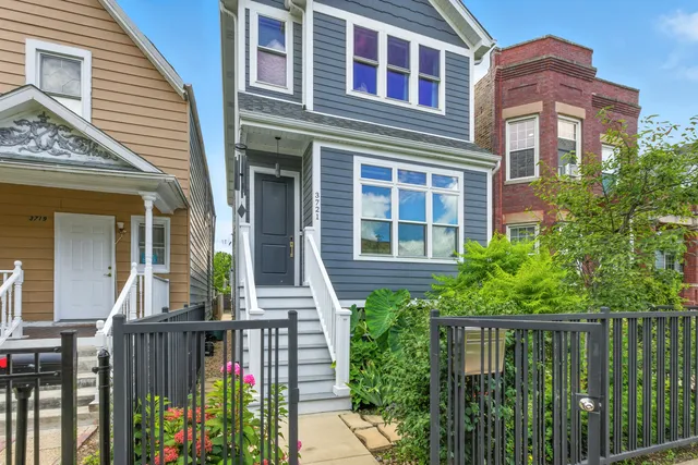 a front view of a house with a garden