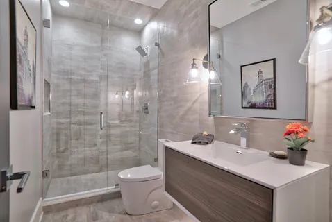 a bathroom with a sink toilet and shower