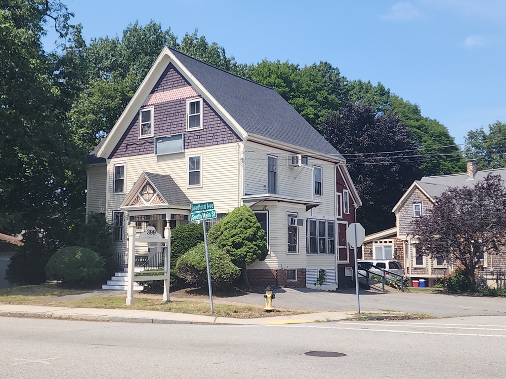 a view of a house and a yard