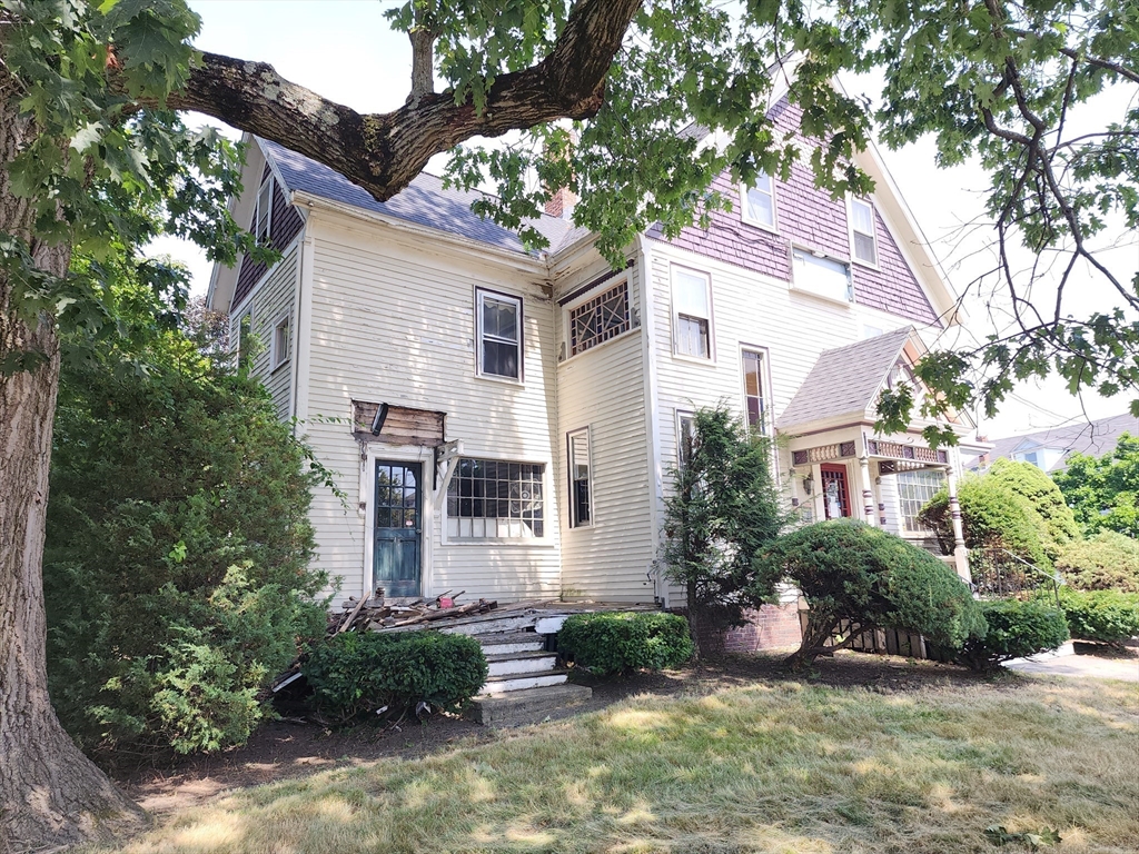 399 South Main Street Haverhill, MA 01835 - Photo 3 of 8 a front view of a house with a yard and potted plants