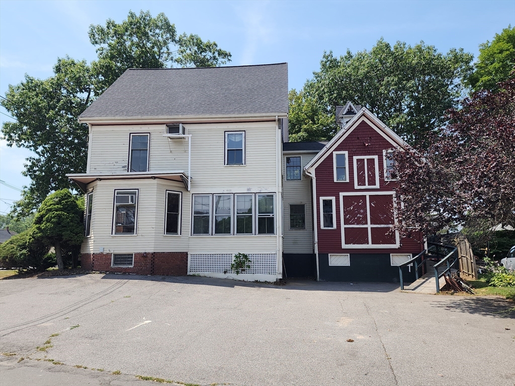 399 South Main Street Haverhill, MA 01835 - Photo 4 of 8 a front view of a house with a yard and garage