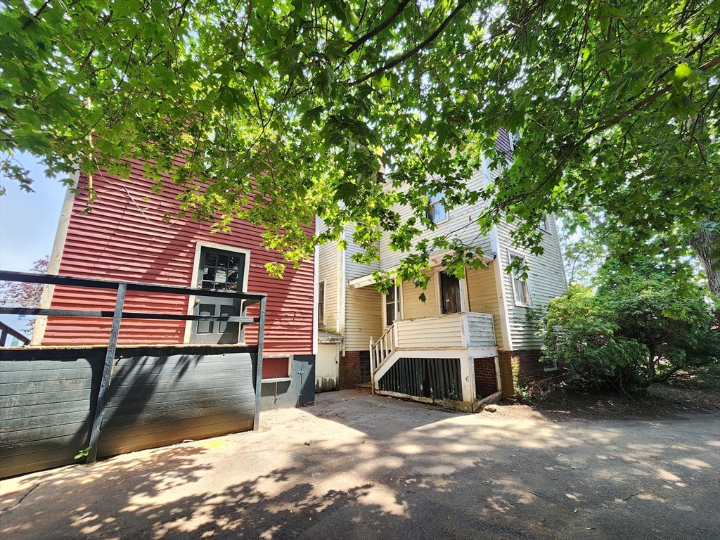 399 South Main Street Haverhill, MA 01835 - Photo 6 of 8 a front view of a house with a yard and trees