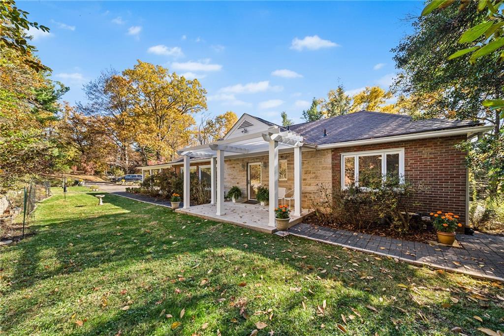 a front view of house with yard outdoor seating and green space