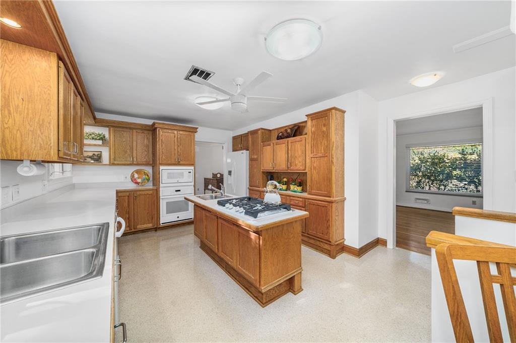 101 Buckingham Road Pittsburgh, PA 15215 - Photo 12 of 44 a open kitchen with stainless steel appliances granite countertop a stove and a refrigerator